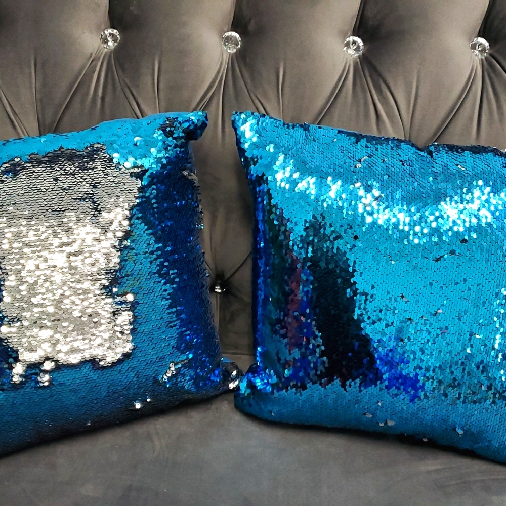 A pair of blue silver sequin cushion